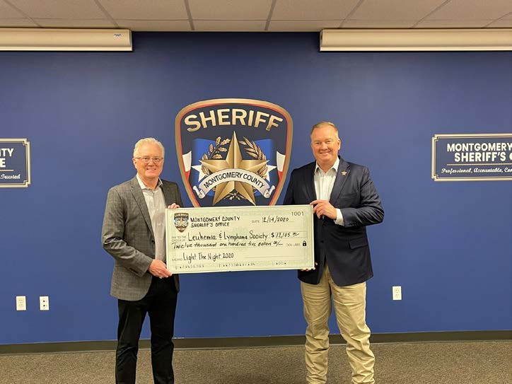 Photo of Sheriff Rand Henderson giving $12,105.00 check to the Leukemia and Lymphoma Society.